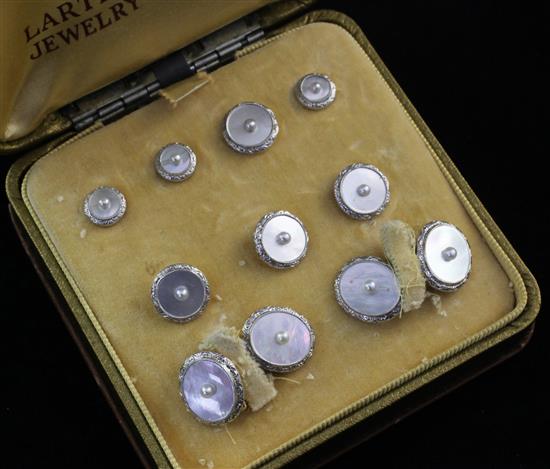 A 14ct gold, mother of pearl and seed pearl set nine piece dress stud set, in box.